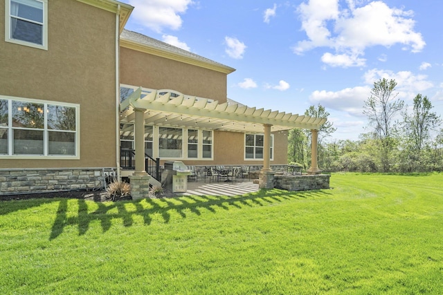 back of property featuring a lawn, a pergola, a patio area, and stucco siding