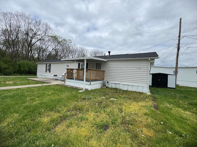 1049 Harmon Ave Unit C82, Columbus, OH 43223 - rear view of house featuring a lawn, an outdoor structure, a patio, and a shed