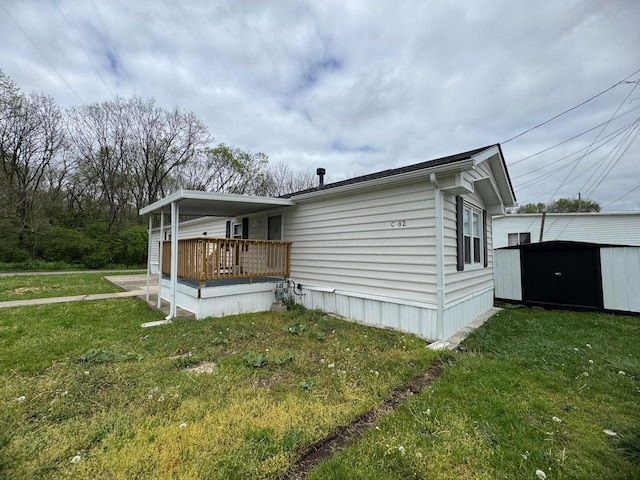 1049 Harmon Ave Unit C82, Columbus, OH 43223 - exterior space featuring a storage unit, a wooden deck, an outbuilding, and a yard