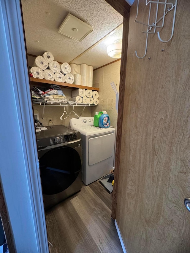 1049 Harmon Ave Unit C82, Columbus, OH 43223 - clothes washing area featuring wood finished floors, a textured ceiling, separate washer and dryer, and laundry area