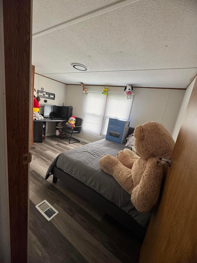 1049 Harmon Ave Unit C82, Columbus, OH 43223 - bedroom featuring visible vents, wood finished floors, and a textured ceiling