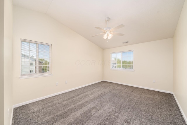 spare room featuring ceiling fan, vaulted ceiling, carpet, and visible vents