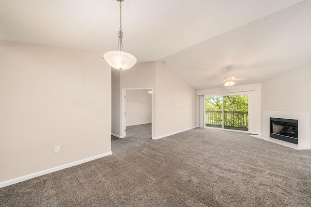unfurnished living room with a ceiling fan, a fireplace, baseboards, lofted ceiling, and carpet