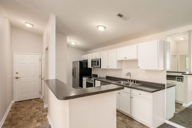 kitchen featuring a sink, white cabinets, dark countertops, and stainless steel appliances
