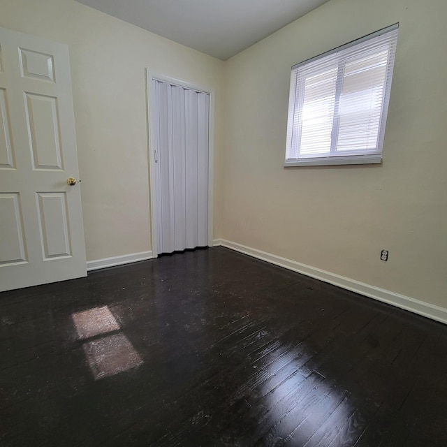 4053 Delphos Ave, Dayton, OH 45402 - unfurnished bedroom with a closet, hardwood / wood-style flooring, and baseboards