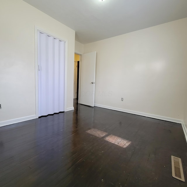 4053 Delphos Ave, Dayton, OH 45402 - empty room featuring dark wood-style flooring, visible vents, and baseboards