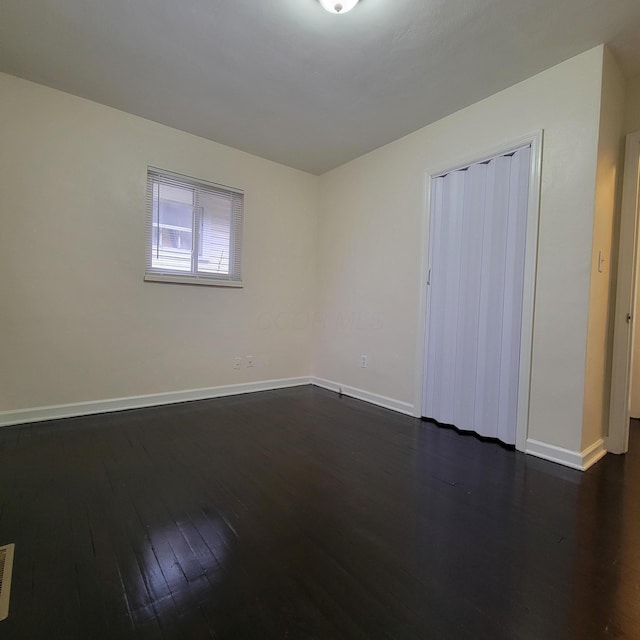 4053 Delphos Ave, Dayton, OH 45402 - unfurnished room with dark wood-style floors, baseboards, and visible vents