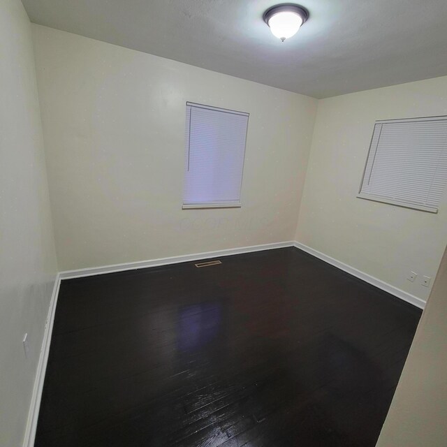 4053 Delphos Ave, Dayton, OH 45402 - spare room featuring dark wood-style flooring and baseboards