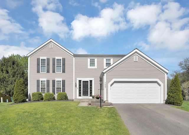 7567 Simmswood Ct, Dublin, OH 43016 - view of front of property with an attached garage, a front lawn, and aphalt driveway