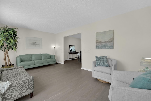 7567 Simmswood Ct, Dublin, OH 43016 - living area featuring baseboards, a textured ceiling, and wood finished floors
