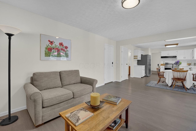 7567 Simmswood Ct, Dublin, OH 43016 - living area featuring baseboards, dark wood-style flooring, and a textured ceiling