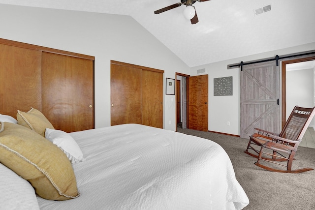 7567 Simmswood Ct, Dublin, OH 43016 - carpeted bedroom featuring multiple closets, vaulted ceiling, a barn door, and visible vents