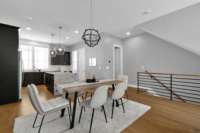 754 N 6th St, Columbus, OH 43215 - dining space with baseboards, light wood finished floors, recessed lighting, and a notable chandelier