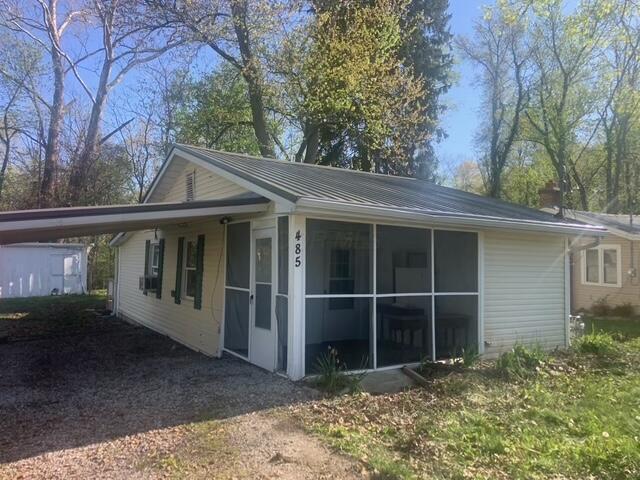 485 Union Ave, Buckeye Lake, OH 43008 - view of property exterior featuring an attached carport and a sunroom