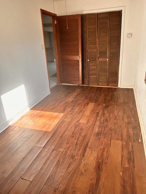 485 Union Ave, Buckeye Lake, OH 43008 - unfurnished bedroom with wood finished floors, a closet, and baseboards