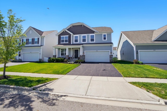 craftsman inspired home featuring an attached garage, stone siding, driveway, and a front yard