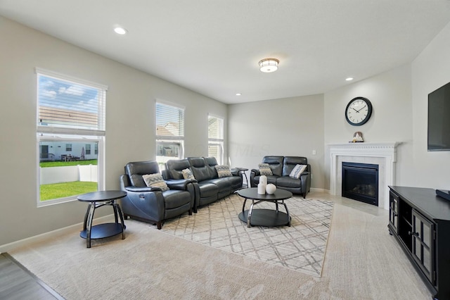 living area featuring light wood-style floors, baseboards, a fireplace, and recessed lighting