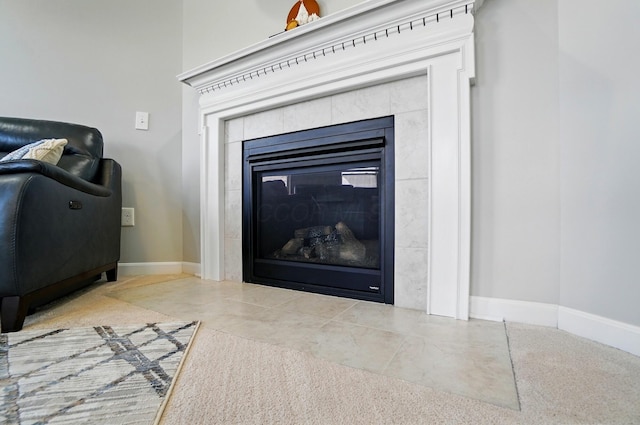 room details featuring baseboards and a tile fireplace