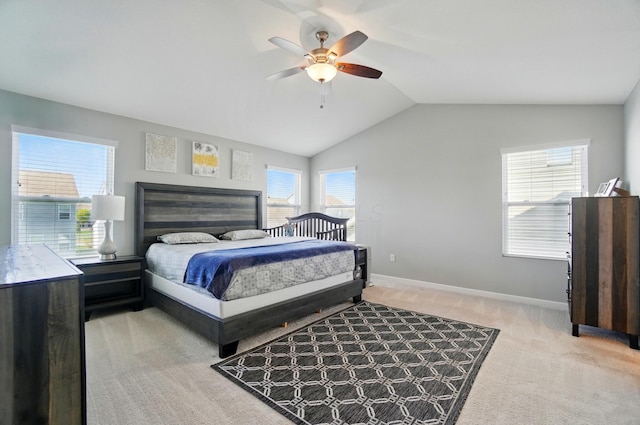 bedroom featuring a ceiling fan, baseboards, light carpet, and vaulted ceiling