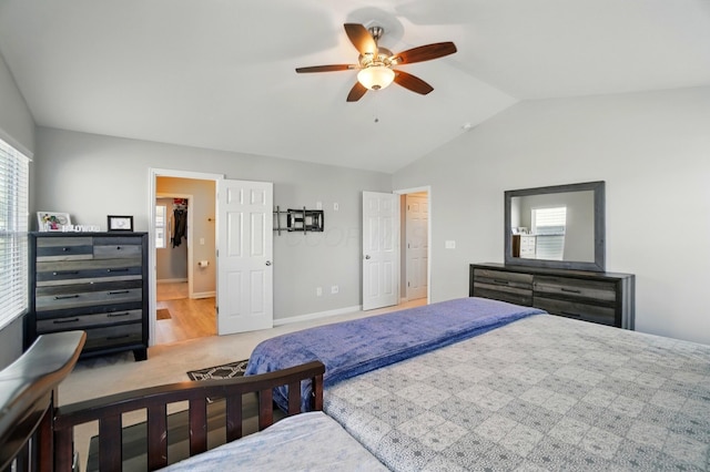 bedroom featuring a ceiling fan, baseboards, carpet, and lofted ceiling