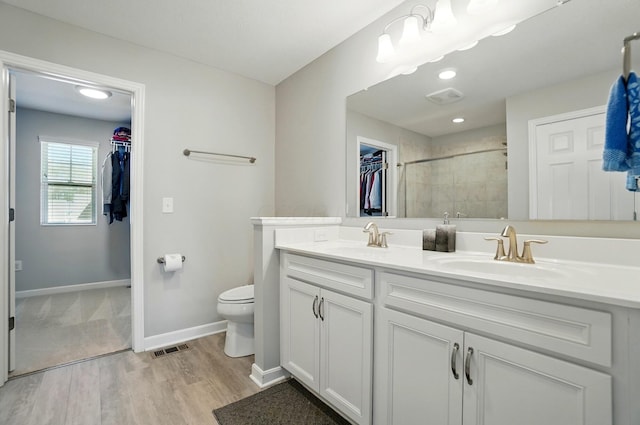 bathroom with toilet, visible vents, and a sink