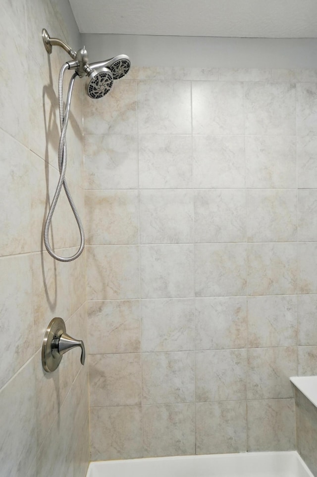 interior details with a tile shower