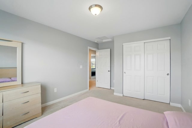 bedroom featuring baseboards, light carpet, and a closet
