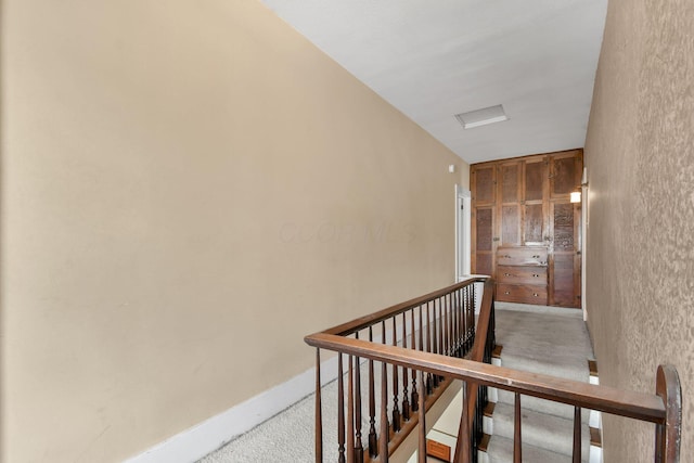 stairs featuring baseboards and carpet floors