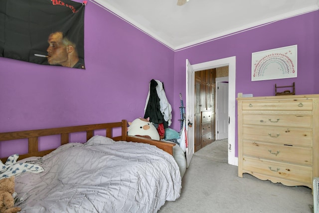bedroom featuring crown molding and carpet