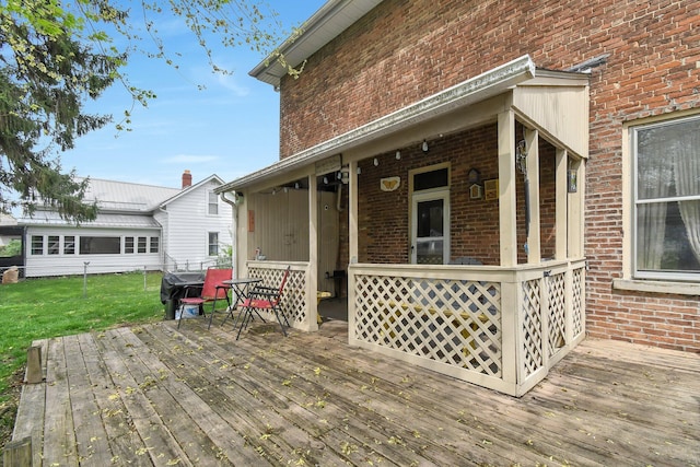 wooden deck with a lawn