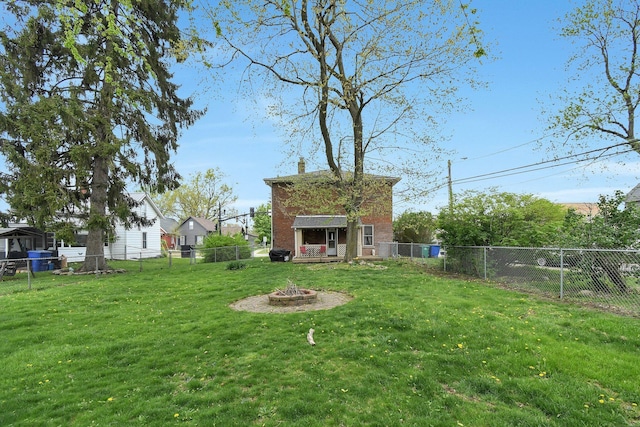 view of yard with a fire pit and a fenced backyard