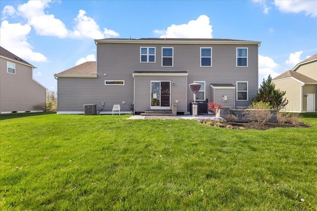 rear view of property featuring central AC unit and a yard