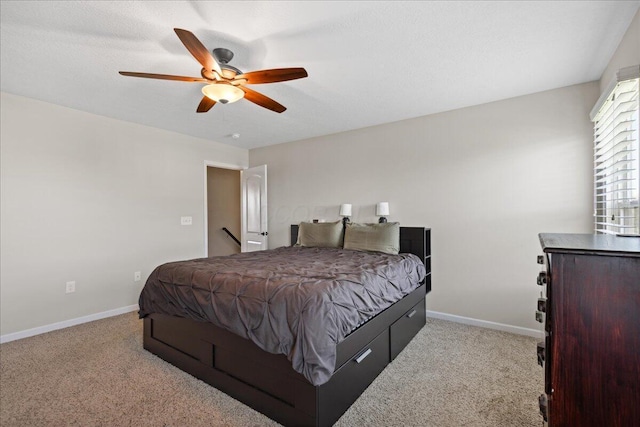 bedroom featuring baseboards, ceiling fan, and carpet flooring