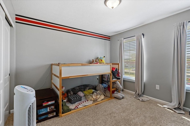 bedroom with carpet flooring and baseboards
