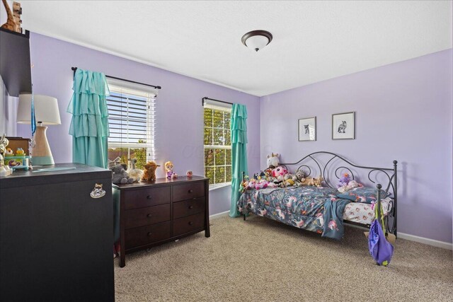 carpeted bedroom with baseboards