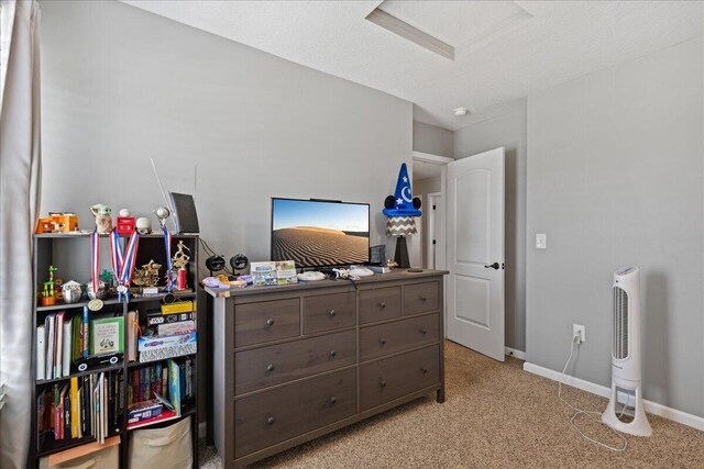 bedroom with baseboards and light colored carpet