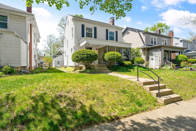 view of front of property with covered porch, a residential view, a front yard, and a chimney