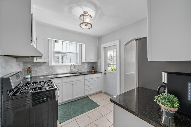 kitchen with white cabinetry, tasteful backsplash, a sink, and stainless steel gas stove