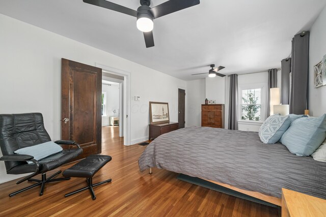 bedroom featuring baseboards, ceiling fan, and wood finished floors