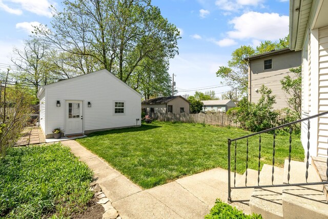 view of yard with fence and an outdoor structure
