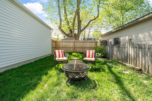 view of yard featuring a fire pit and fence
