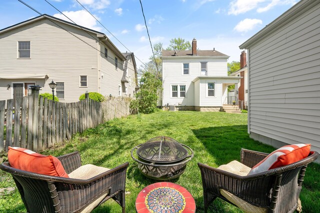 view of yard with fence and a fire pit