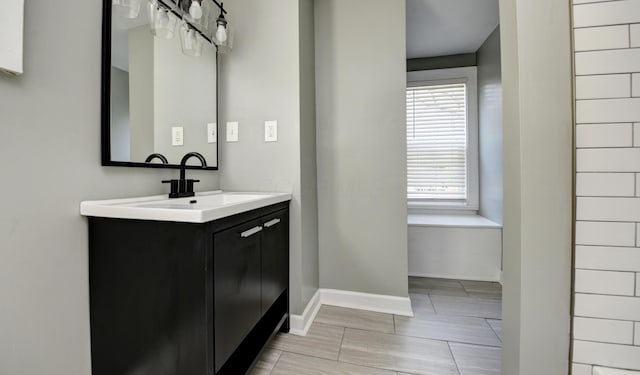 bathroom featuring baseboards and vanity