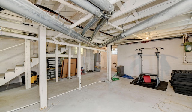 basement with stairs and water heater