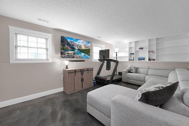 living area with a textured ceiling, dark wood finished floors, built in shelves, baseboards, and visible vents