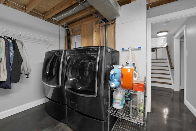 laundry room with baseboards, laundry area, and washing machine and dryer