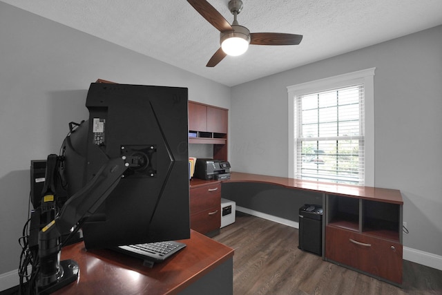 office space with a ceiling fan, a textured ceiling, dark wood finished floors, and baseboards