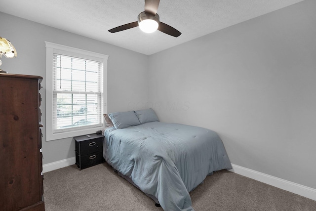 bedroom featuring baseboards, a ceiling fan, carpet flooring, and a textured ceiling