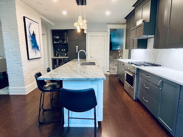 kitchen featuring high end stove, backsplash, and dark wood-style floors