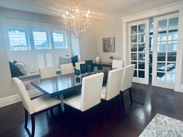 dining space with dark wood finished floors and a notable chandelier
